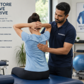Physiotherapist helping patient during spine injury rehab session at Book My Rehab.