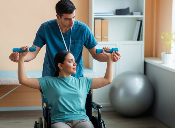 Physiotherapist assisting a cardiac rehabilitation patient with supervised exercise therapy in a modern rehabilitation clinic.