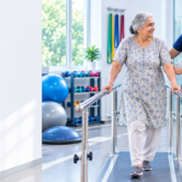 elderly-rehabilitation-fall-prevention-confidence Physiotherapist helping an elderly patient improve balance and mobility during rehabilitation