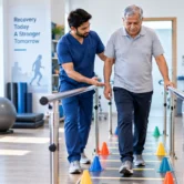 stroke-rehabilitation-walking-balance Physiotherapist helping a stroke survivor improve walking and balance during rehabilitation